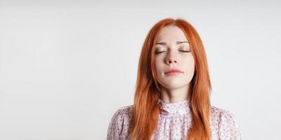 Calm peaceful woman meditates with closed eyes - introspection mindfulness and self-care photo