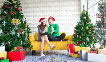 Merry Christmas and New Year concept. Young Caucasian lover with christmas theme clothing celebrate and exchange presents each other in the party with fun and happiness photo