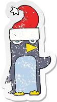 retro distressed sticker of a cartoon penguin in christmas hat vector