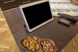 Comfortable home office. Tablet, nuts, phone, photo