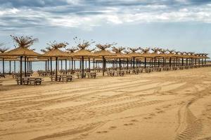 Empty sandy beach and rows resting places in the failed tourist season. photo