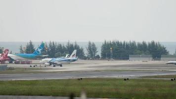 PHUKET, THAILAND NOVEMBER 26, 2017 - Tractor pulling Bangkok Airways Airbus at Phuket Airport. Tourism and travel concept video