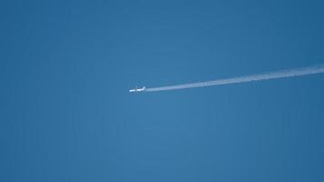 Airplane flying at high altitude with contrail video