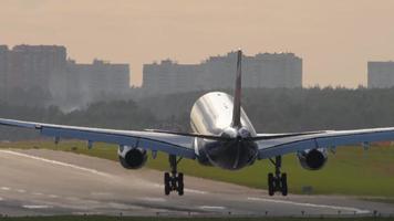 MOSCOW, RUSSIAN FEDERATION SEPTEMBER 12, 2020 - Footage of Aeroflot airline plane landing and braking, rear view. Slow motion, aircraft touching the runway while landing video