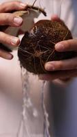 Chef cuts coconut open to extract water video