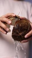 Chef cuts coconut open to extract water
