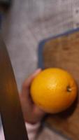 A chef slices orange with a sharp knife video