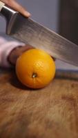 Cutting Orange in half with a sharp knife