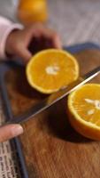 A chef slices orange with a sharp knife video