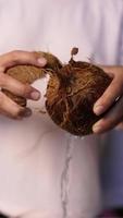 Chef cuts coconut open to extract water video