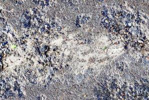 Detailed view on asphalt surfaces of different streets and roads with cracks photo