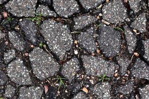 Detailed view on asphalt surfaces of different streets and roads with cracks photo