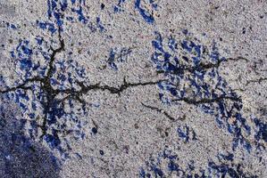 Detailed view on asphalt surfaces of different streets and roads with cracks photo