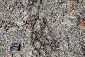 Detailed view on asphalt surfaces of different streets and roads with cracks photo