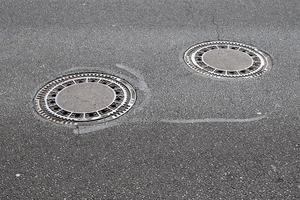 Detailed view on asphalt surfaces of different streets and roads with cracks photo