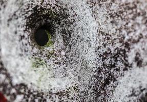 Detailed close up of bullet holes from gun shots in a traffic sign photo