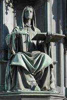 Prague, Czech Republic, 2014. A statue of a woman holding the books of Thomas Aquinas photo