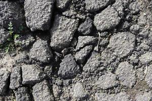 Detailed view on asphalt surfaces of different streets and roads with cracks photo