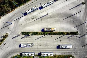 Aerial view from drone of bus at bus station with interesting shadows