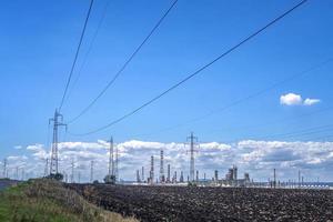 Rows of electrical towers and power lines. Horizontal view photo