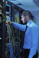 young it engineer in datacenter server room photo