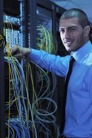 young it engineer in datacenter server room photo