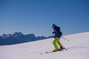 Skier having fun while running downhill photo