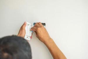 Electrician installing Wire cables for socket plug to a concrete. Renovation, Repair, service and development of home and apartment concepts photo