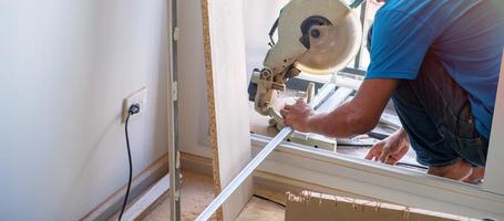 Man cutting Wood with circular saw photo