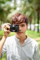 man holding digital camera outdoor photo