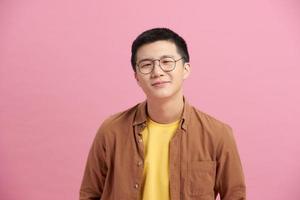 Asian man cheerful wearing glasses happy smile on pink background photo