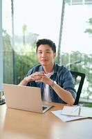 Man working with laptop in co working space. photo