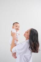 Safe in his mother's arms. Mother and her baby girl at home. photo