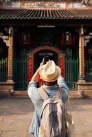 Asian man take a photo at the temple.