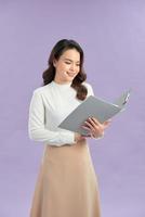 Portrait of young pretty positive girl smiling looking at camera with crossed arms over purple background. photo