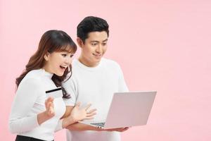 Excited happy couple doing online shopping in internet. photo