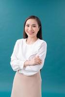 Young asian business woman isolated on blue background photo