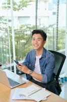 Young asian business men working with laptop phone in coffee shop cafe. photo