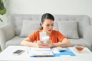 young woman use calculator analyze charges check utility bills photo