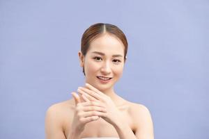 Young beautiful woman applying hands cream photo