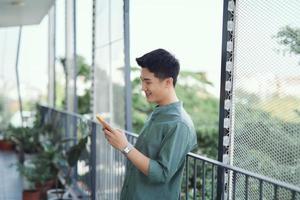 Portrait of handsome guy using his cell phone photo