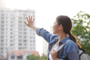 Young pretty hipster cheerful girl posing on the street at sunny day photo