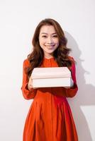 Portrait of beautiful Asian woman holding gift box, photo