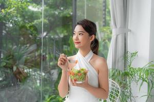young attractive asian woman who eats photo