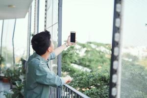 Young Asian man taking selfie photo