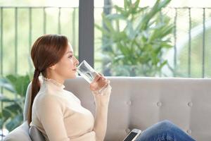 woman drink water and feel happily at home photo