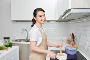 Woman cooking delicious dinner at home photo