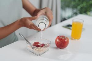 Young woman prepares a low-calorie breakfast on a prescription photo