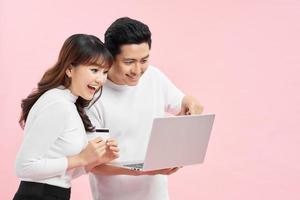 Excited happy couple doing online shopping in internet. photo