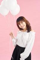 Graceful slim birthday girl posing with balloons photo